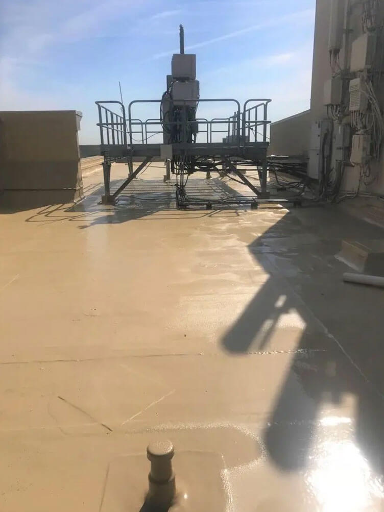 Commercial roof with restored parapet and coated surface