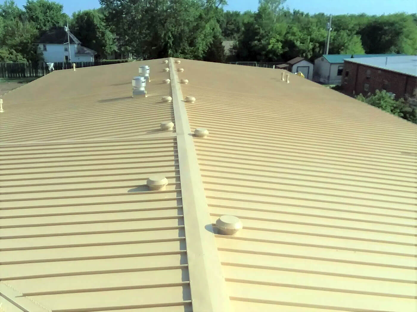 Repaired and coated standing seam metal roof